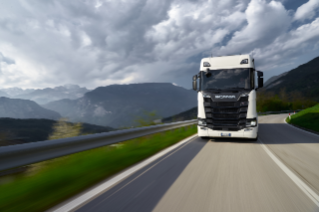 White truck driving on road in mountains