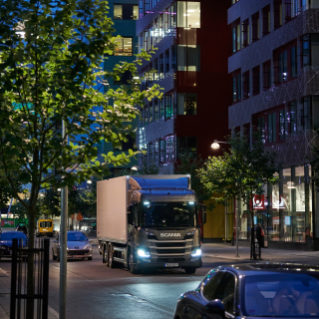 Truck driving on street in city
