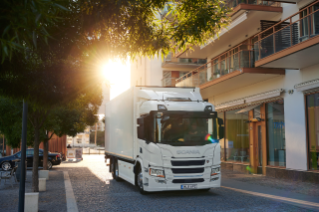 White truck driving on city street 