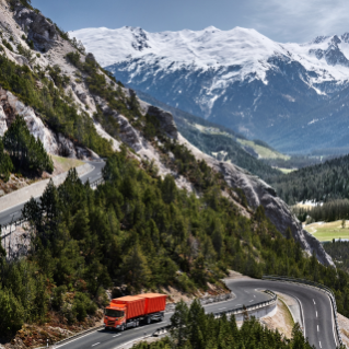 Red truck driving on road in the mountains