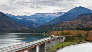 Truck driving on bridge over water