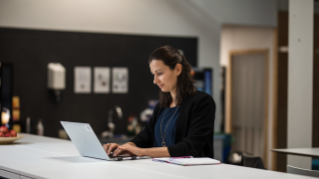 Woman with laptop in office environment