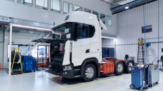 White truck in workshop with front hatch open