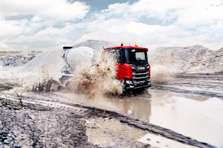 Red truck driving in splashing water