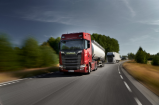 Two trucks driving on road