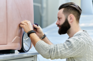 Man with beard wirking with a model of NXT