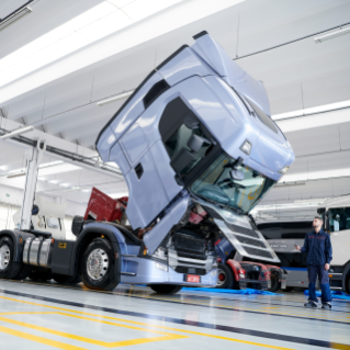 Truck in workshop with tilted cab