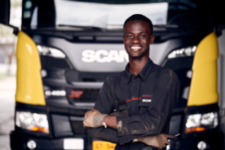 Male service technician in front of truck